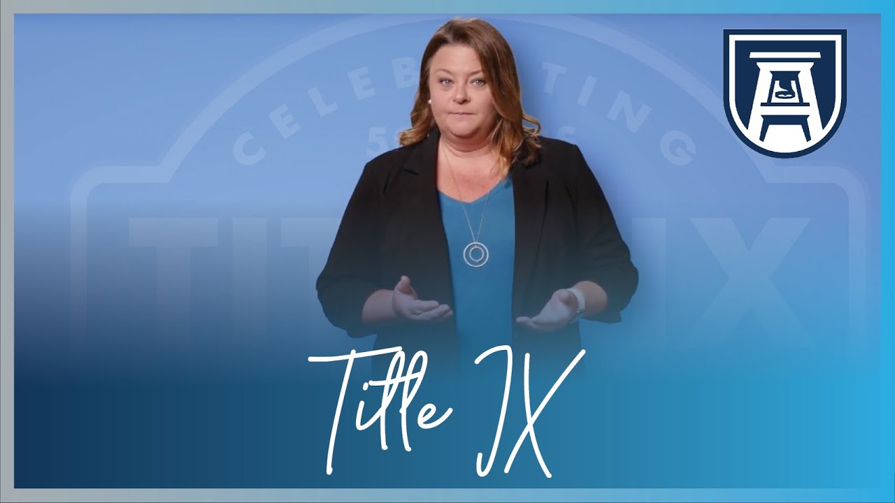 Woman stands in front of an AU Backdrop