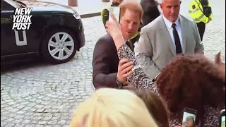 Prince Harry playfully reprimands overzealous fan trying to take a selfie with two phones at once
