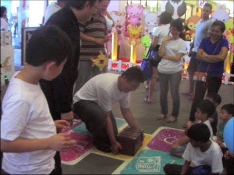 Magician Singapore Patrick Wan performing light and heavy chest magic