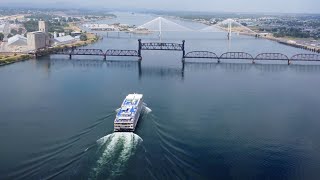 Aerial View Of A Cruise Ship Going Under Two Bridges On The Columbia River