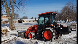 Removing snow in preparation for a firewood delivery  Outside the cab view