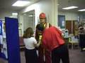Fall arrest harness being put onto mannequin man by member of the public at a Safety clothing and PPE exhibition by ARCO at family open day at BAE (British Aerospace Engineering) systems in Rochester #1 (flash) Fall arrest harness being put onto mannequin man by member of the public at a Safety clothing and PPE exhibition by ARCO at family open day at BAE (British Aerospace Engineering) systems in Rochester #1 (flash)