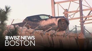 Pickup truck hangs off edge of Boston bridge after crash