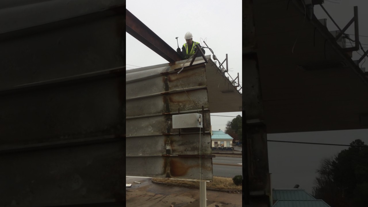 Aaron drops the soffit on a gas station awning.