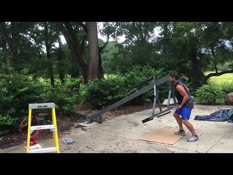 Installation of basketball hoop alone.