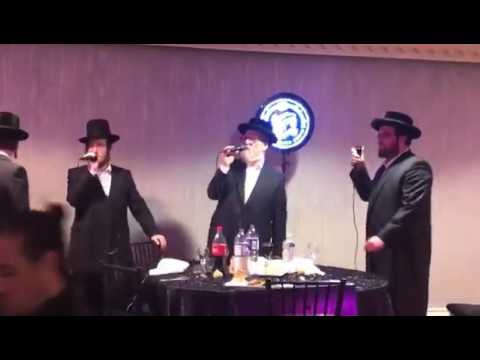 Michoel schnitzler singing at a bar mitzvah in Boro park. With the shira choir and moshe glick