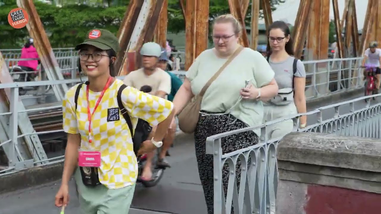 Catch a glimpse of strolling across the historic Long Bien Bridge.