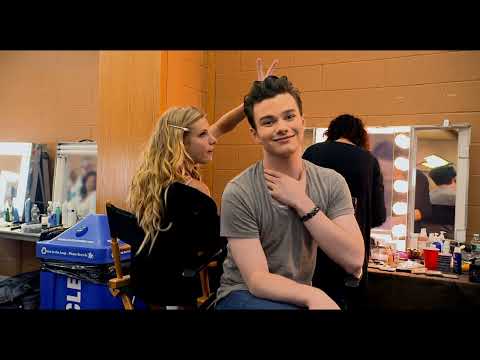 Official trailer frame: Glee cast on a LED-lit stage with confetti cannons mid-burst