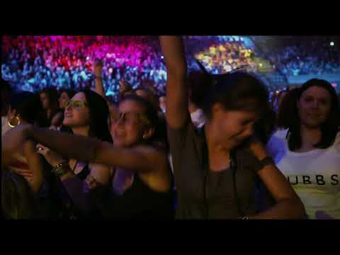 Trailer frame: confetti rain and spotlight bloom during the finale