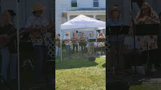 Adorable group plays 60's song get together on ukuleles in a front yard in Paw Paw, West Virginia
