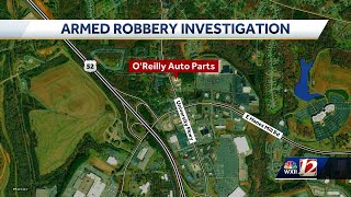 Officers investigate an armed robbery at O’Reilly’s Auto Parts