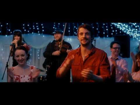 Trailer collage of pub interior, singalong, and ceilidh dancing, matching diegetic Irish tunes