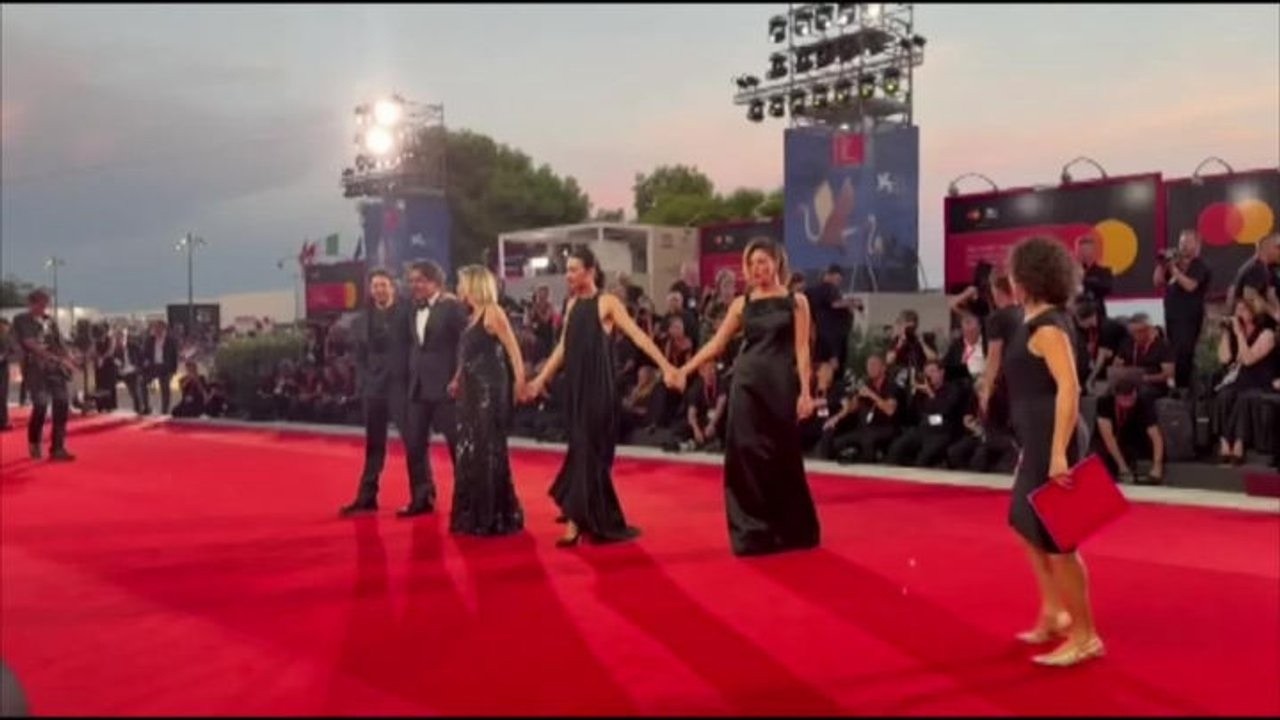 Venezia 83, il cast del film "L'estranea" sfila mano nella mano sul red carpet
