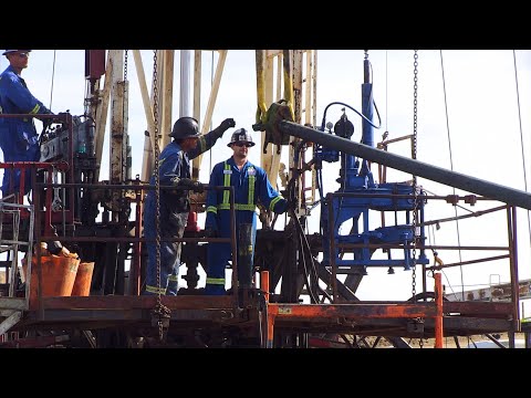 Independent Well Servicing pulling tubing in summer at Oungre, Saskatchewan