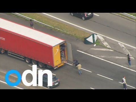 Migrants jump onto moving lorry amid Calais travel chaos