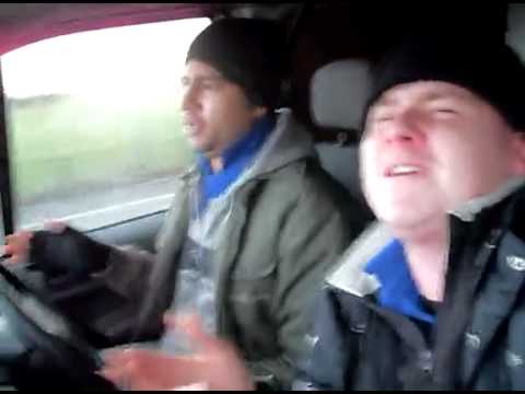 Two Blokes 'Singing' in a Van