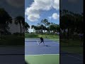 Brian Battistone's jump serve with the two-handled tennis racket