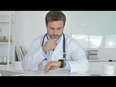 Doctor Using Smartwatch in Clinic | Stock Footage - Videohive