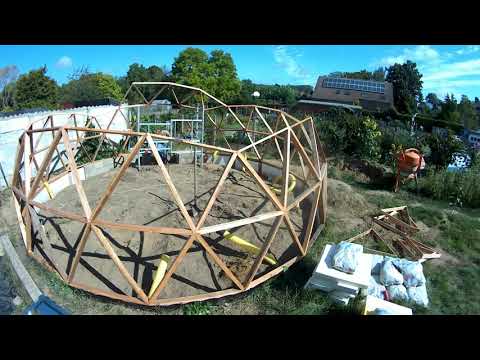 Buildinge geodesic dome greenhouse with wood triangles