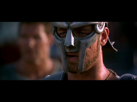Gladiator (2000) trailer frame of Maximus in the Colosseum, close-up with dust and light shafts