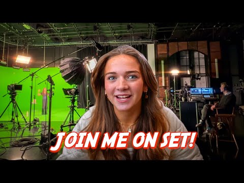 Smiling young woman on a TV studio set with green screen and lighting rigs, foregrounded by bold text 'JOIN ME ON SET!'.