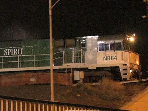 Freight train departs Dynon freight yards at night