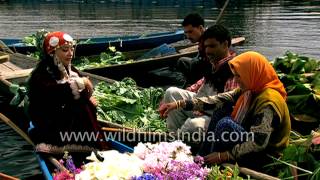Beautiful Kashmiri girls sell fresh flowers and vegetables on boats in Srinagar, India