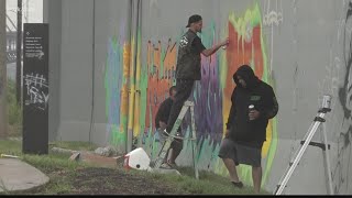 Paint Louis brightens St. Louis floodwall