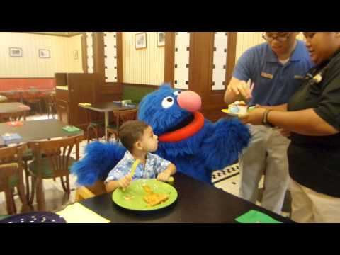 Grover gives Ezra a birthday cake