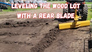 Rookie operator leveling his wood lot with a 3 point blade.  Will he make a mess of it?