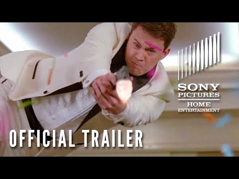 Trailer frame: undercover duo navigating high school corridors, echoing the score’s sprinting pulse