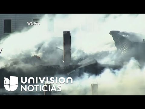 Bomberos combaten un incendio en una edificación de tres pisos en Chelsea, Massachusetts.