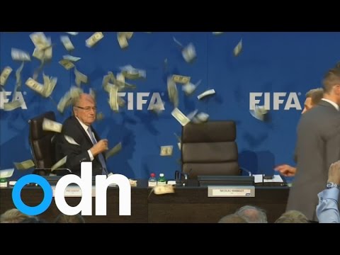 Sepp Blatter showered with banknotes as prankster Lee Nelson storms Fifa press conference
