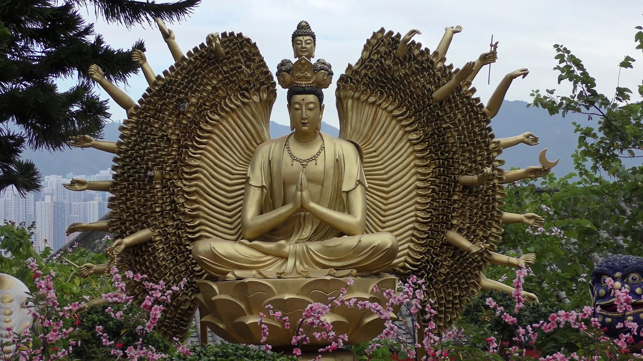 Walk the Buddha-lined path to reach the hilltop monastery.