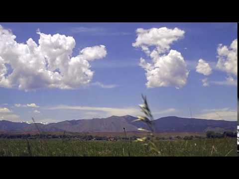 Panning Timelapse of cumulus clouds forming over foothills