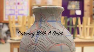 Using a grid to carve a pattern on coil pottery