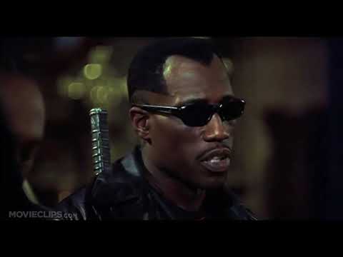 Blade II official trailer frame: Blade in black leather drawing his sword under blue strobe lights
