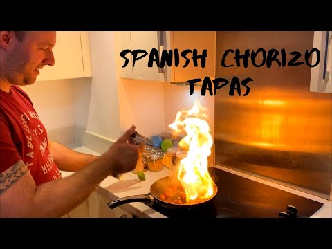 How to make tapas - Spanish chorizo tapas with baby tomatoes, olives peppers and red wine.
