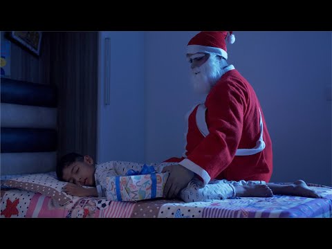 Santa Claus keeping the Christmas gift beside a sleeping boy o... | Indian Stock Footage | Knot9