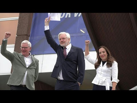 Julian Assange raises fist upon arrival at European Council | AFP