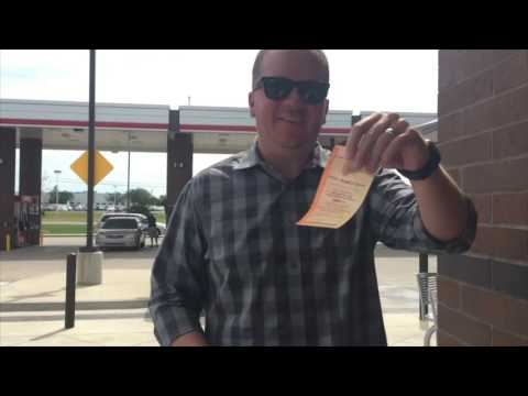 Tommy from Channel 963 buying a Kansas Lottery ticket for the Holiday Millionaire Raffle