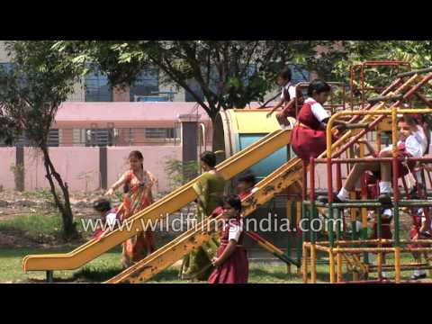 Indian children on school playground in Paradeep, with swings and slides
