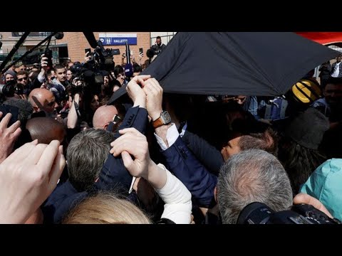 Chaos as French Secret Service rush to protect President Emmanuel Macron with £8000 umbrella (VIDEO)