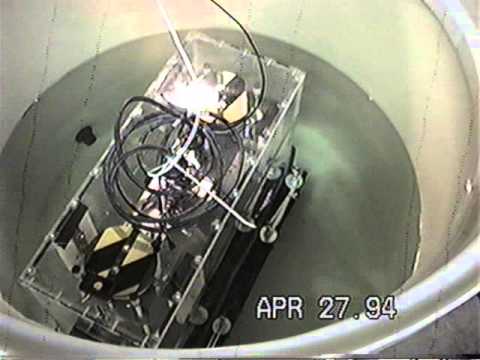 Asymmetric Mass System Moving in Water