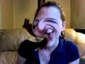 Girl laughing while making funny faces on distorted webcam