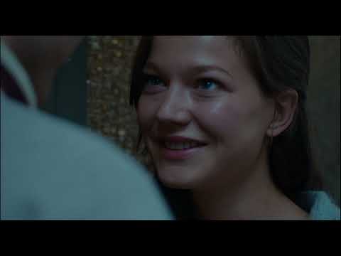 Trailer still: book event applause; the music slides from suave to slightly anxious