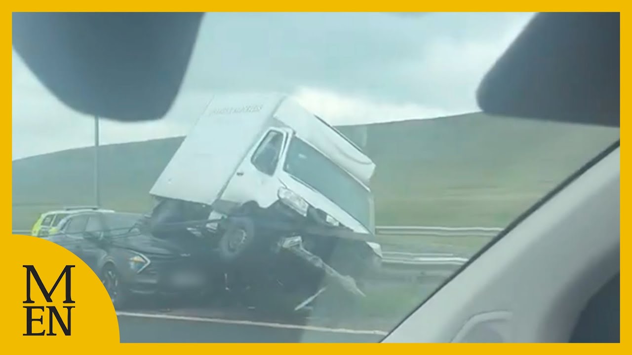 Horror moment lorry smashes into central reservation with car wedged ...