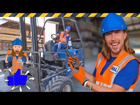 Warehouse scene with a forklift and two workers in safety gear; foreground worker smiles at the camera in an orange vest and blue helmet.