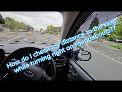 How do I check my distance to the kerb while turning right on roundabouts?