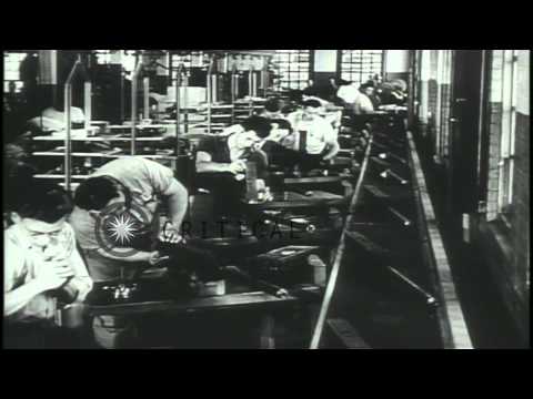 Workers manufacture ammunition in a factory and US Army soldiers advance towards ...HD Stock Footage